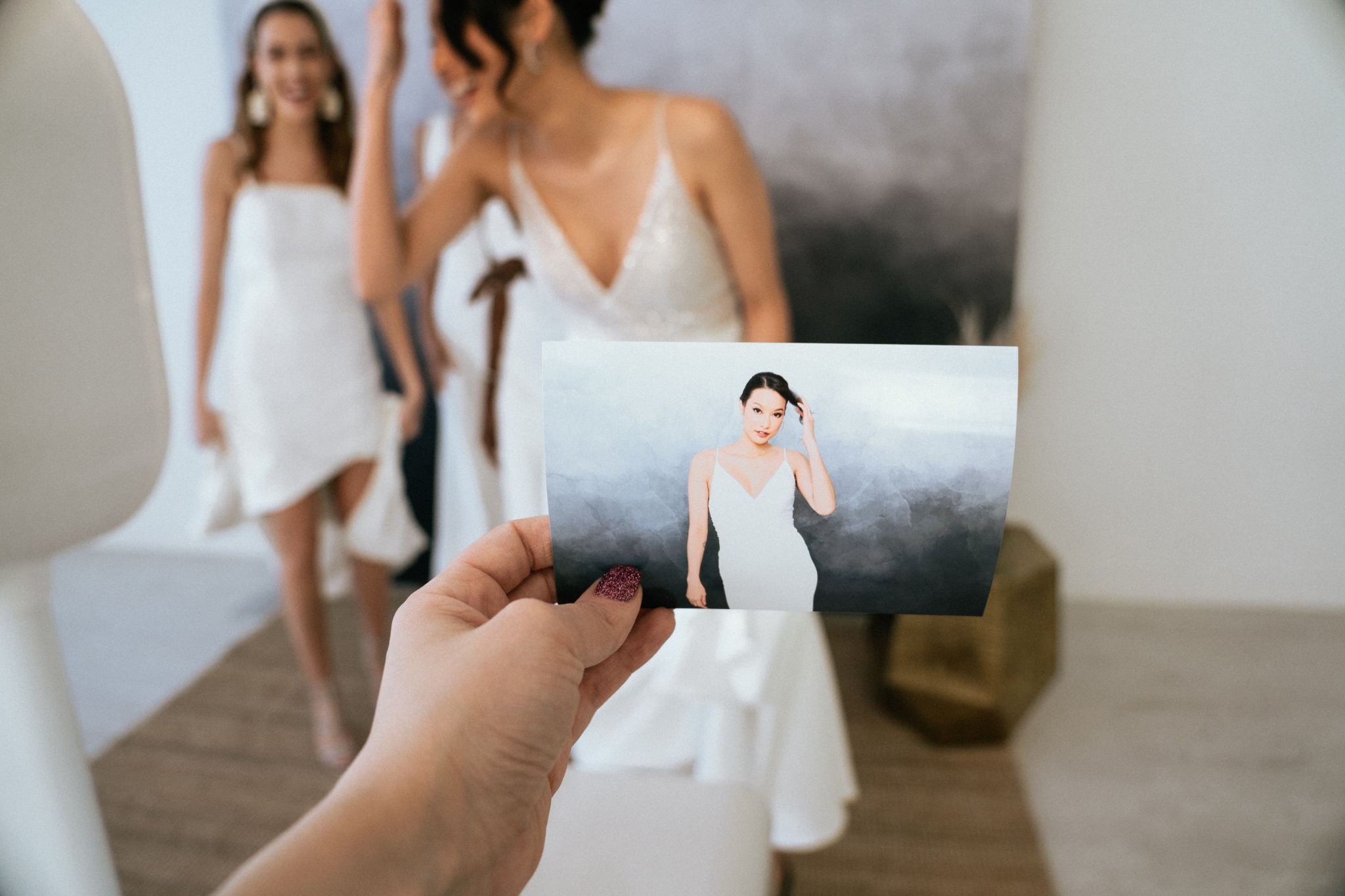 A guest holding a full-size printed portrait